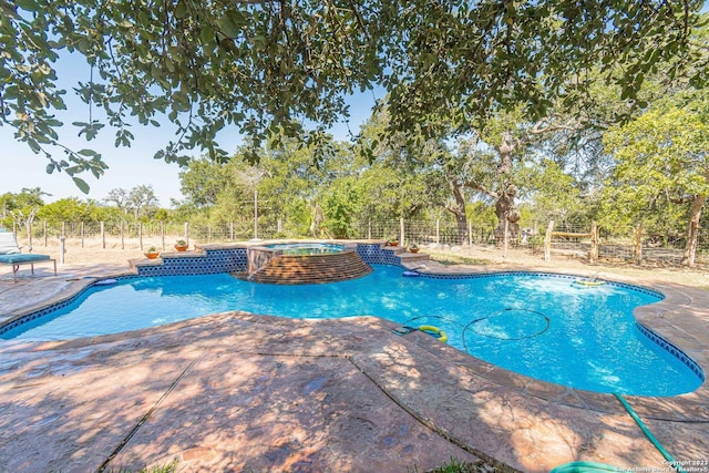 view of pool featuring a patio and an in ground hot tub