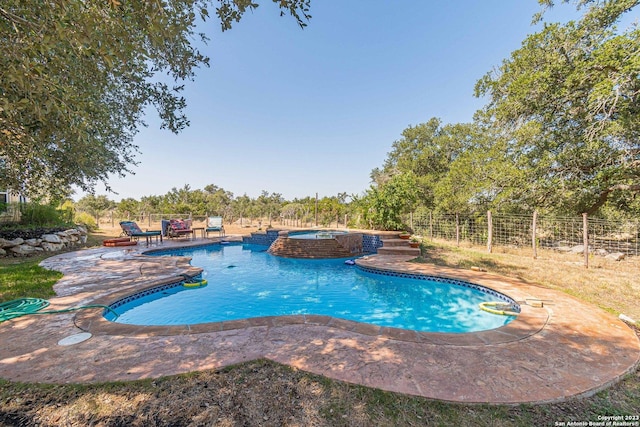 view of pool featuring an in ground hot tub and a patio area