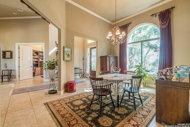 dining area with an inviting chandelier, light tile patterned floors, ornamental molding, and a high ceiling