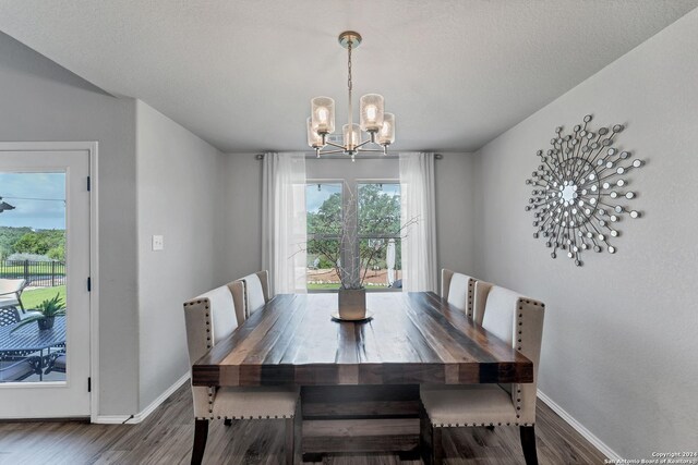 dining area featuring dark hardwood / wood-style flooring and a notable chandelier