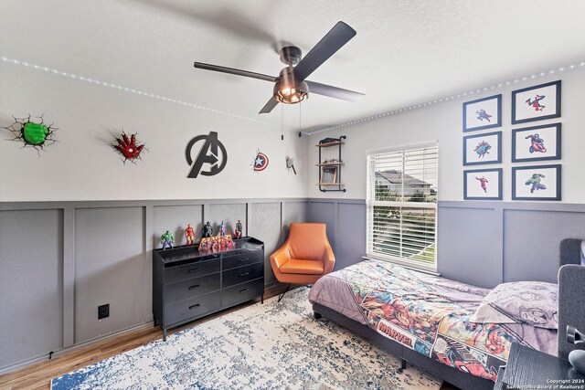 bedroom with ceiling fan and light wood-type flooring