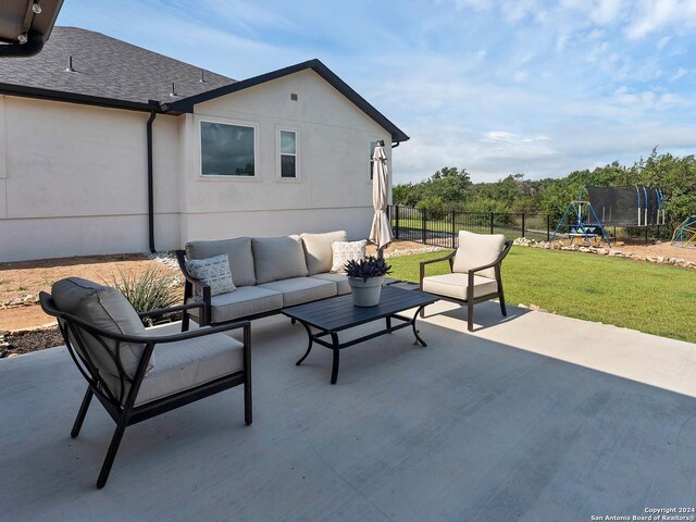 view of patio / terrace with a trampoline and an outdoor living space