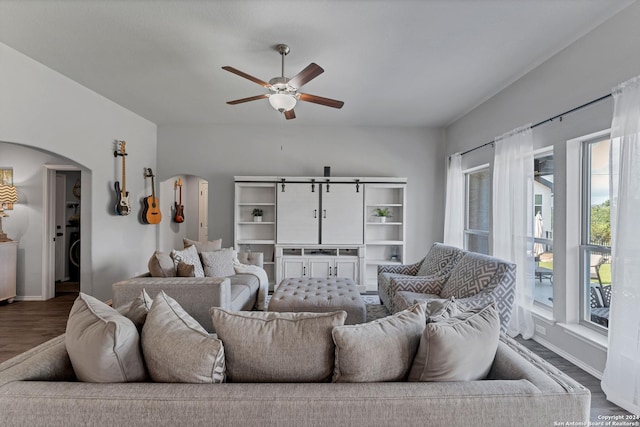 living room featuring washer / clothes dryer, dark wood-type flooring, and ceiling fan