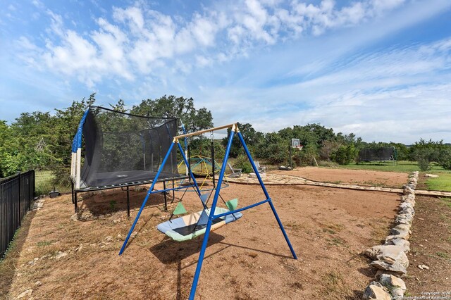 view of jungle gym with a trampoline