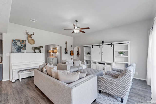 living room featuring wood-type flooring and ceiling fan