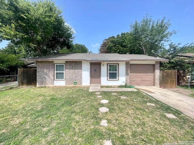 single story home featuring a garage and a front yard