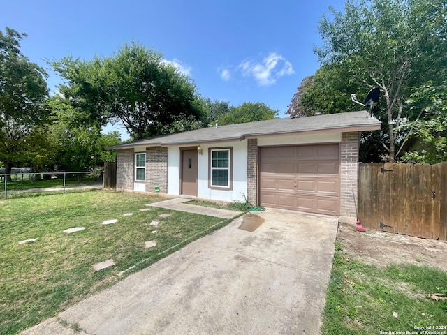 ranch-style home with a garage and a front yard