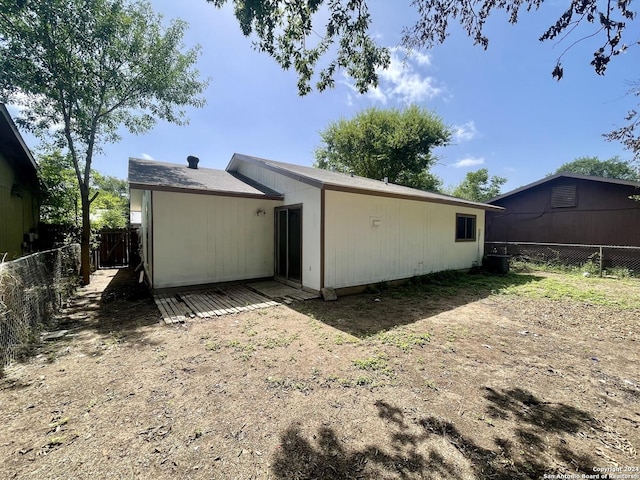 back of property featuring fence and central AC unit