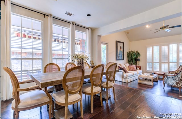 dining space with vaulted ceiling, dark hardwood / wood-style floors, and ceiling fan