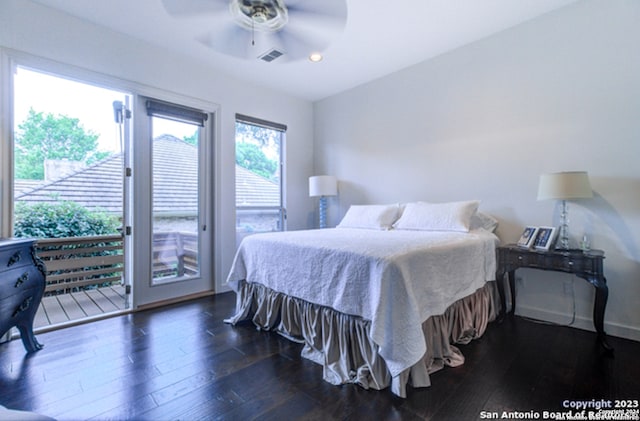 bedroom featuring dark hardwood / wood-style flooring, access to exterior, and ceiling fan