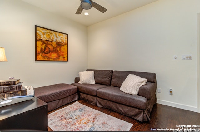 living room with ceiling fan and dark hardwood / wood-style floors