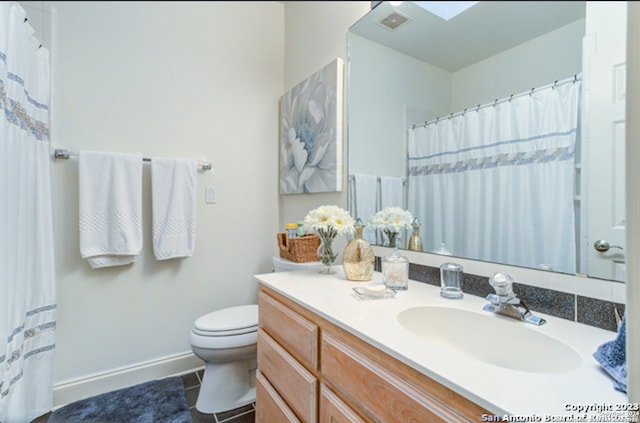 bathroom with tile patterned floors, vanity, and toilet