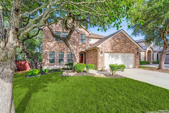 view of front of house with a garage and a front yard