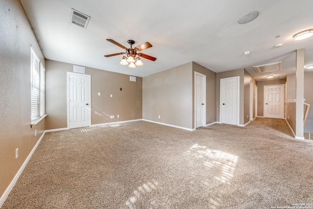 carpeted empty room featuring ceiling fan