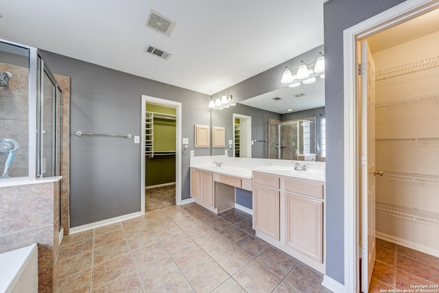 bathroom featuring tile patterned floors, vanity, and an enclosed shower