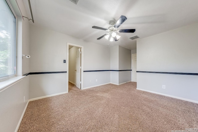 carpeted empty room featuring ceiling fan