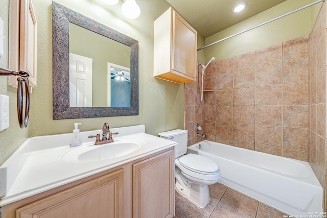 full bathroom featuring tiled shower / bath, tile patterned floors, toilet, and vanity