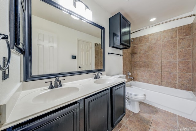 full bathroom featuring tile patterned flooring, vanity, toilet, and tiled shower / bath