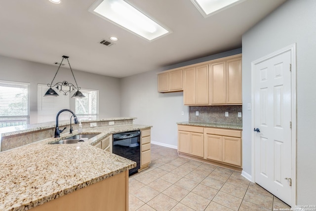 kitchen with pendant lighting, light brown cabinetry, black dishwasher, and sink