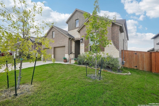 view of front of property with a garage and a front yard