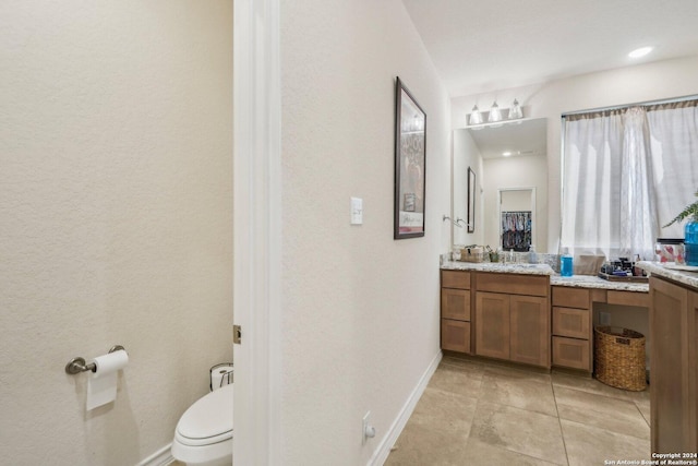 bathroom with vanity, tile patterned floors, and toilet