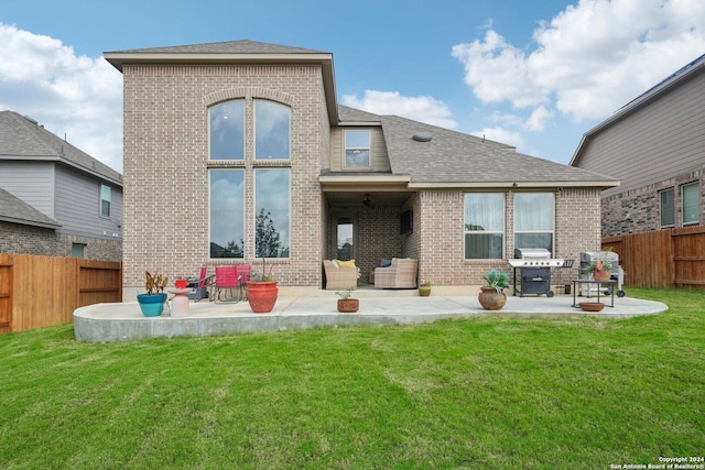 back of house featuring a yard and a patio area