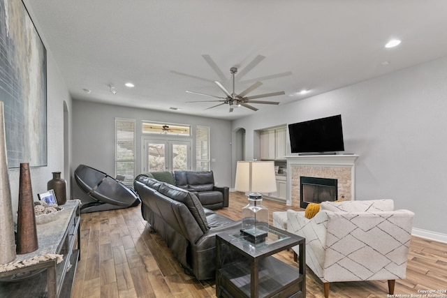 living room with ceiling fan, light wood-type flooring, and french doors