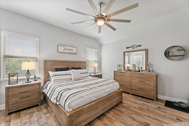 bedroom featuring ceiling fan, lofted ceiling, and light hardwood / wood-style flooring