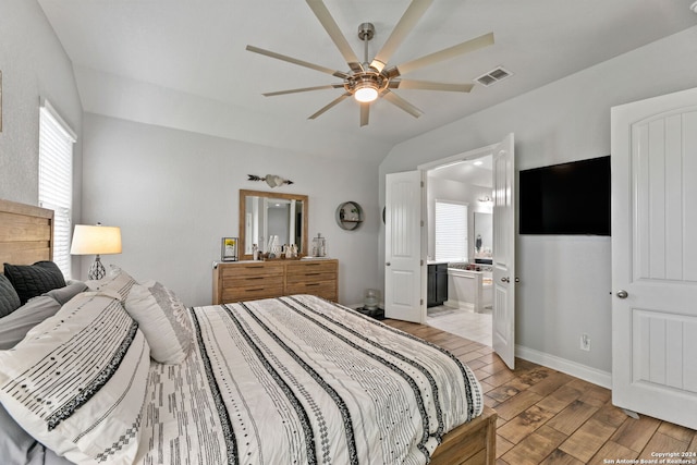 bedroom with light hardwood / wood-style floors and ensuite bathroom