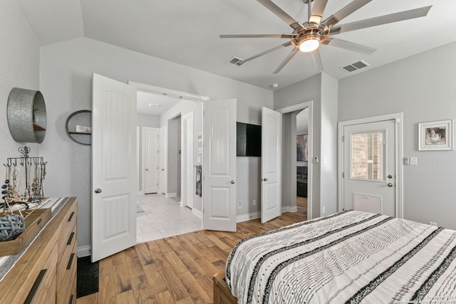 bedroom featuring ceiling fan, lofted ceiling, and light wood-type flooring