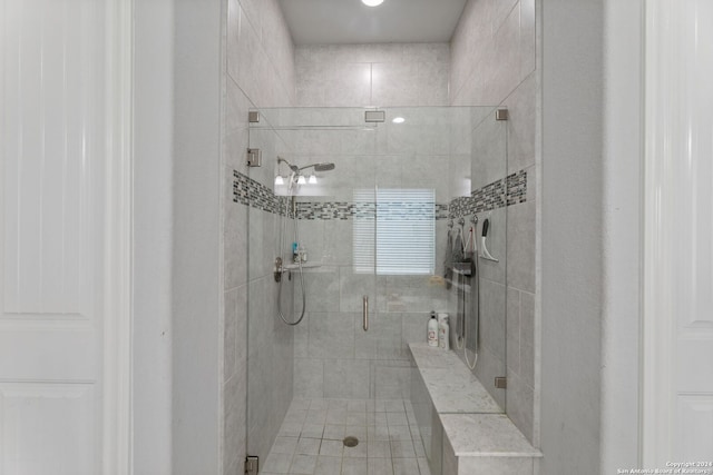 bathroom featuring a shower with shower door