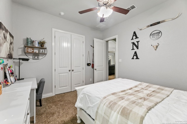 carpeted bedroom with ceiling fan and a closet