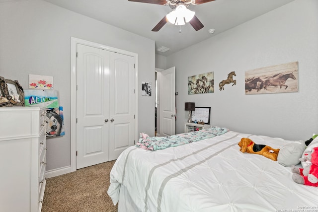 carpeted bedroom featuring ceiling fan and a closet