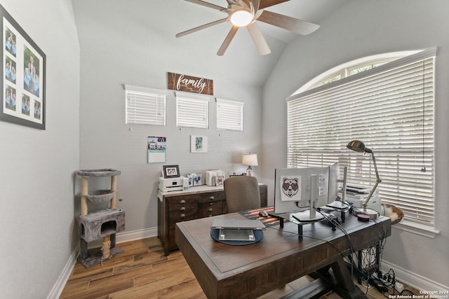 home office featuring lofted ceiling, ceiling fan, and light hardwood / wood-style flooring