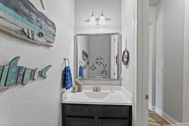 bathroom with vanity, hardwood / wood-style floors, and toilet