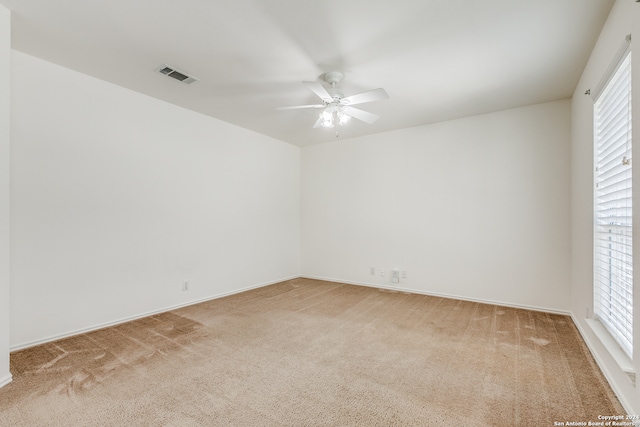 carpeted spare room with ceiling fan