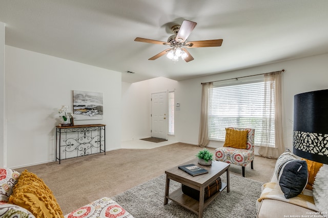 carpeted living room with ceiling fan