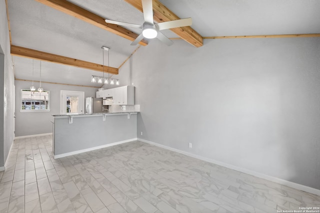 unfurnished living room featuring a textured ceiling, vaulted ceiling with beams, light tile patterned floors, and ceiling fan