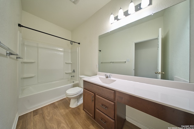 full bathroom featuring hardwood / wood-style flooring, toilet, shower / bathtub combination, and vanity