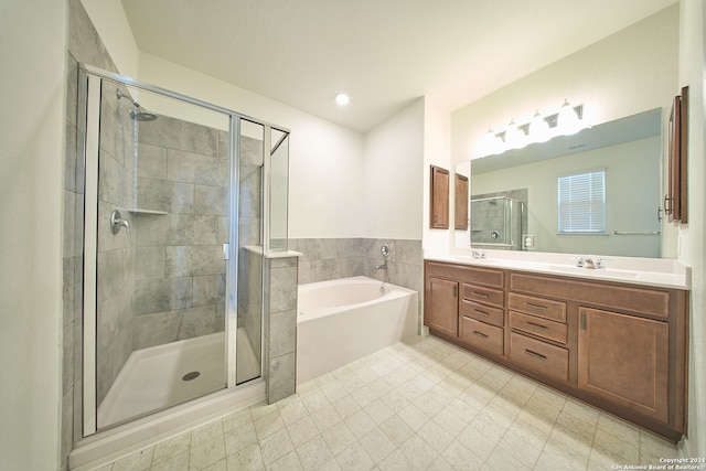 bathroom with tile patterned flooring, shower with separate bathtub, and dual bowl vanity