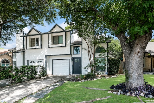 view of front of home with a garage and a front yard