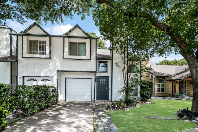 view of front of property featuring a garage and a front yard