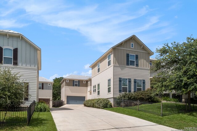 view of front of property with a garage and a front lawn