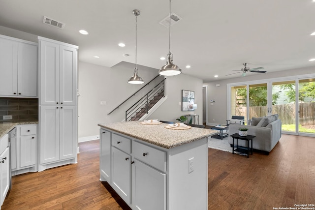 kitchen featuring open floor plan, white cabinets, a kitchen island, and visible vents