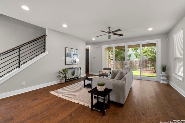 living area with plenty of natural light, dark wood finished floors, recessed lighting, and stairs