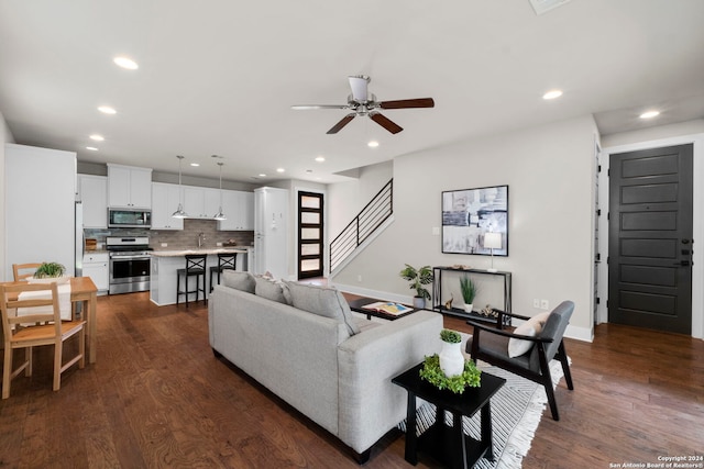 living area with dark wood-style floors, recessed lighting, ceiling fan, and stairway