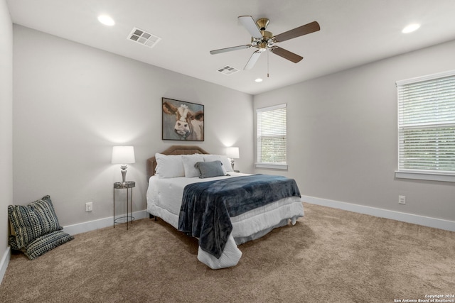 carpeted bedroom featuring baseboards, visible vents, a ceiling fan, and recessed lighting