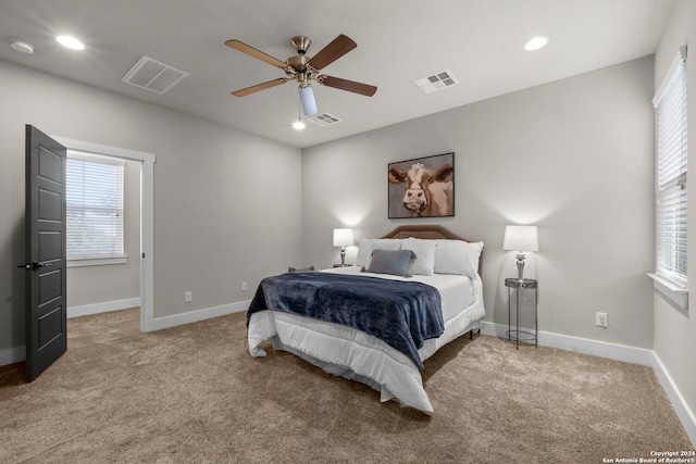 bedroom with visible vents and light colored carpet