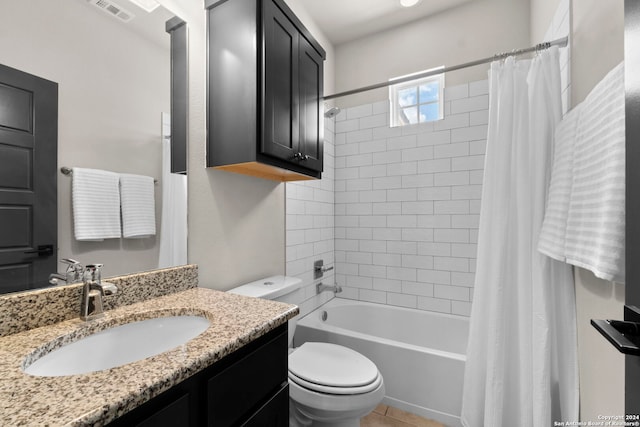 bathroom featuring visible vents, toilet, shower / bath combo, vanity, and tile patterned floors