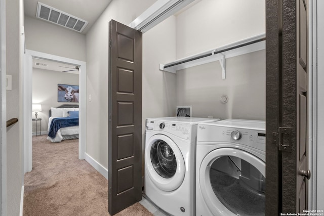 laundry room with light carpet, laundry area, baseboards, visible vents, and separate washer and dryer